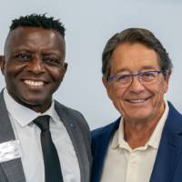 Felix Ngassa and Jim Brooks standing together and smiling at camera